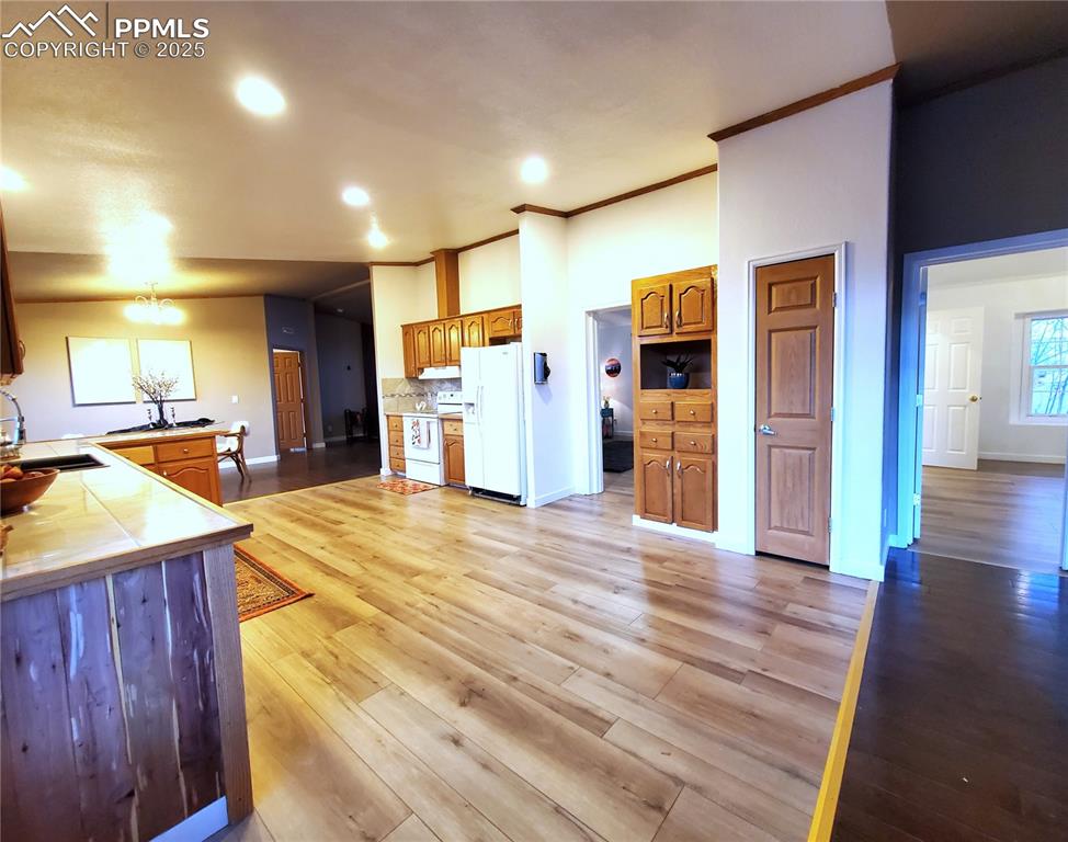 Image 29 of 50: Kitchen: Left looks towards the French doors and master suite, doors to bed