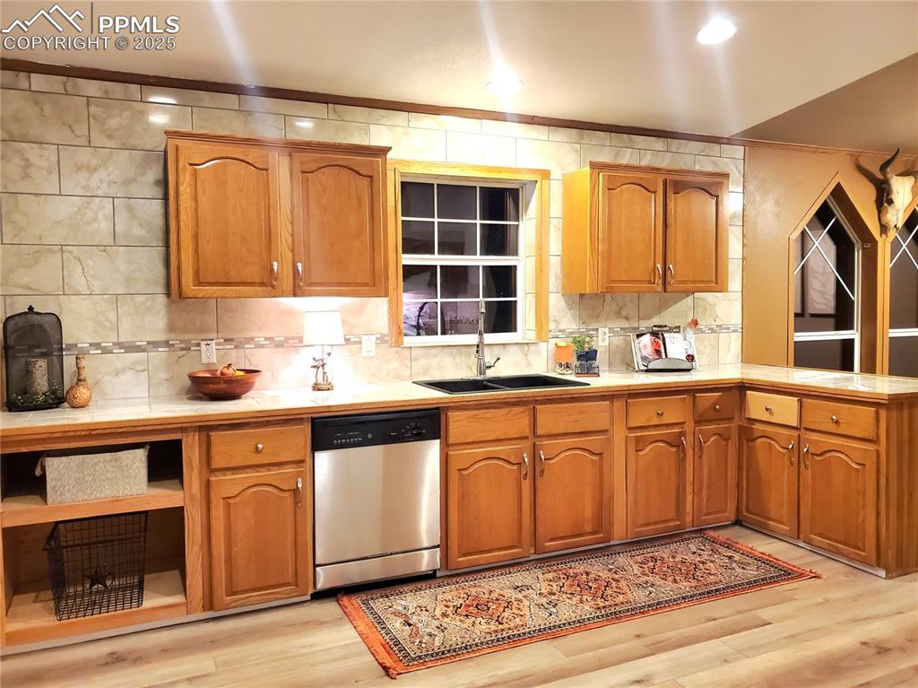 Image 3 of 50: Features beautiful marble look tile countertops and ceiling height backspla