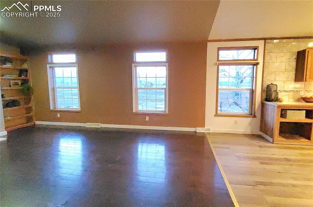 Image 37 of 50: Large family room looks out to the Wet mountain views with wood burning fir