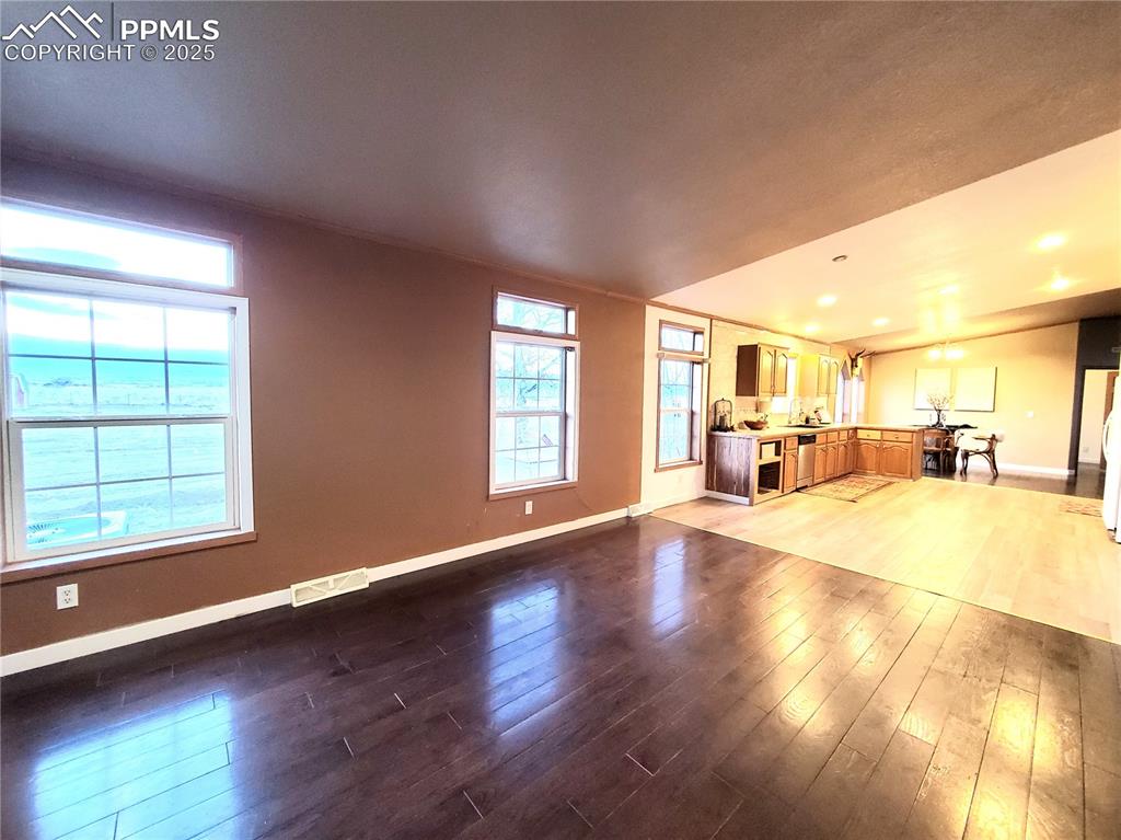 Image 38 of 50: Family room opens to kitchen and looks out to the mountain views