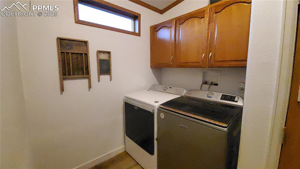 Image 40 of 50: Receives nice lighting from the window, features wonderful storage cabinetr
