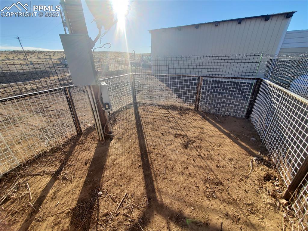 Image 42 of 50: dog or littles fenced play yard which comes off the pet or bonus room at th