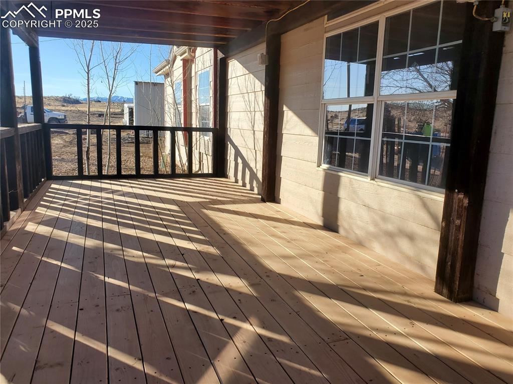 Image 7 of 50: Brand new flooring on the spacious covered front porch which is surrounded 