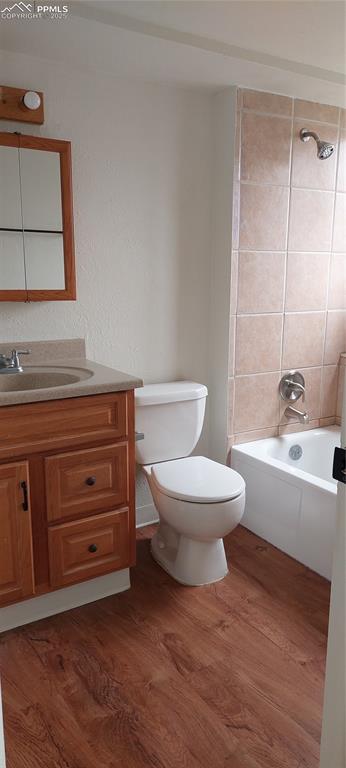 Image 37 of 46: Full bath attached the bedroom featuring dark wood-style vinyl plank floor