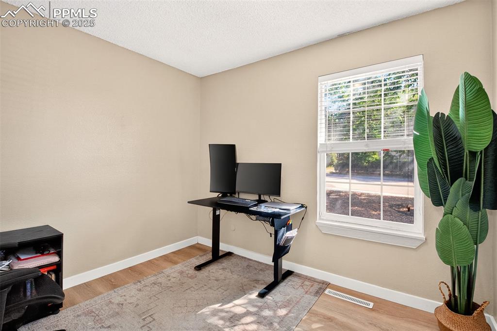 Image 12 of 29: 2nd bedroom, currently used as home office.