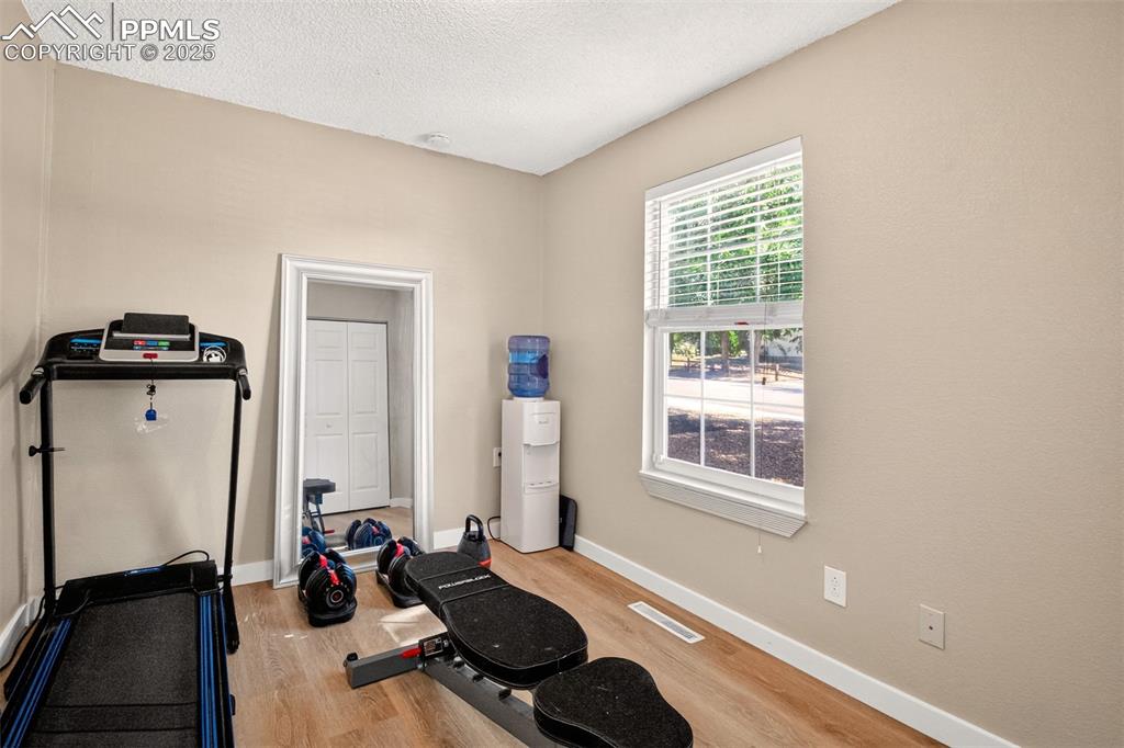 Image 14 of 29: 3rd bedroom, currently used as workout room
