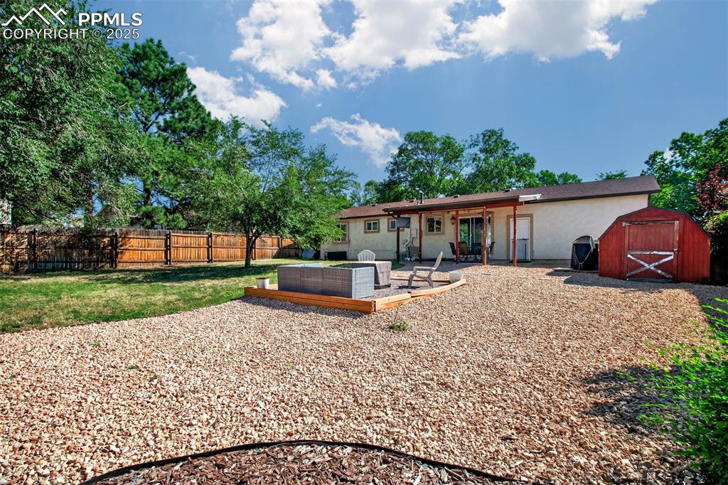 Image 19 of 29: View of the back of the home, large shed!