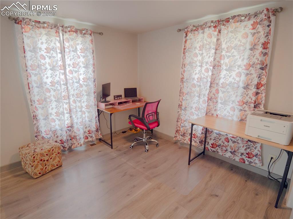 Image 21 of 39: Home office with wood finished floors and baseboards