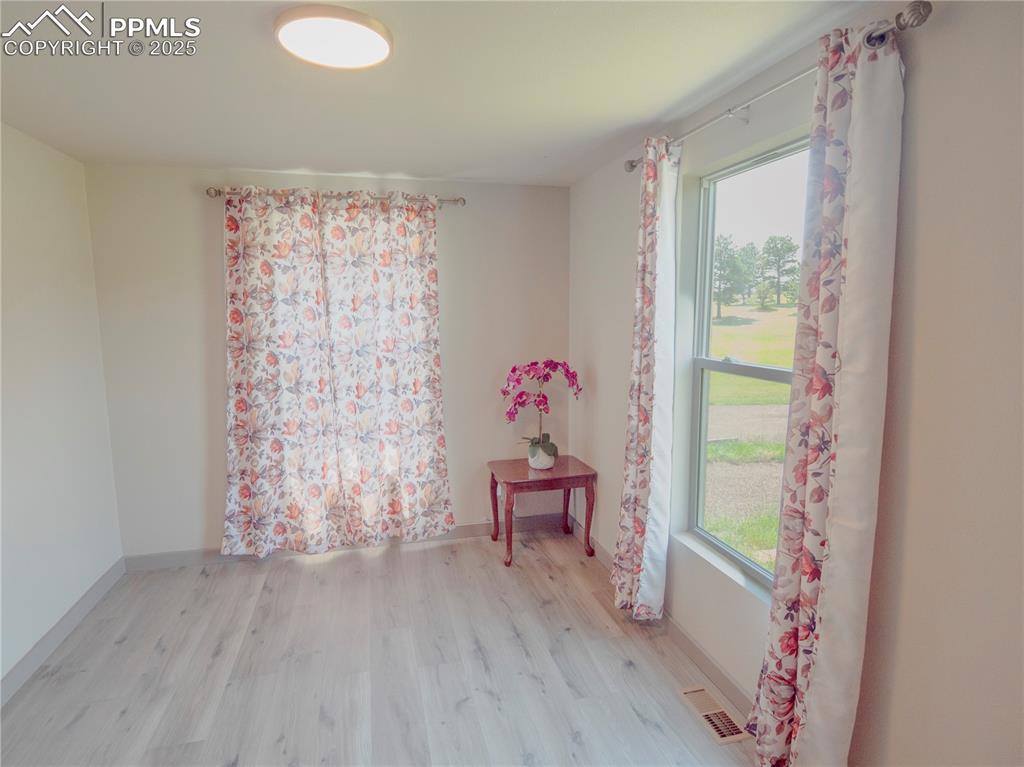 Image 23 of 39: Empty room with wood finished floors