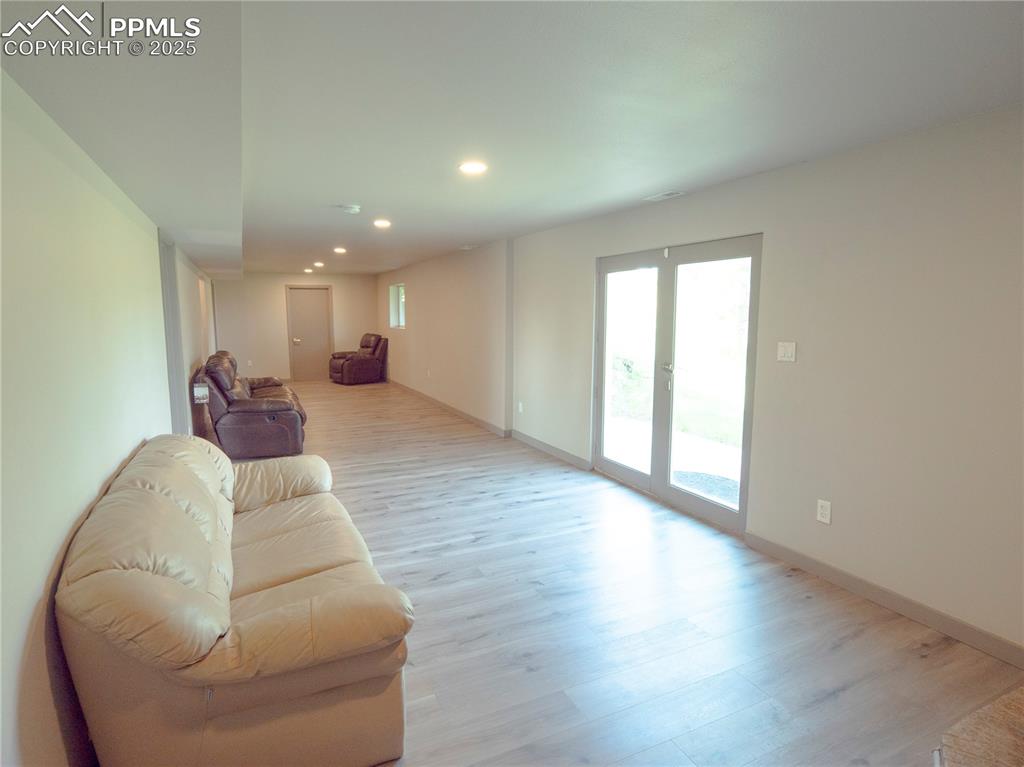 Image 33 of 39: Living room featuring light wood-style floors and recessed lighting