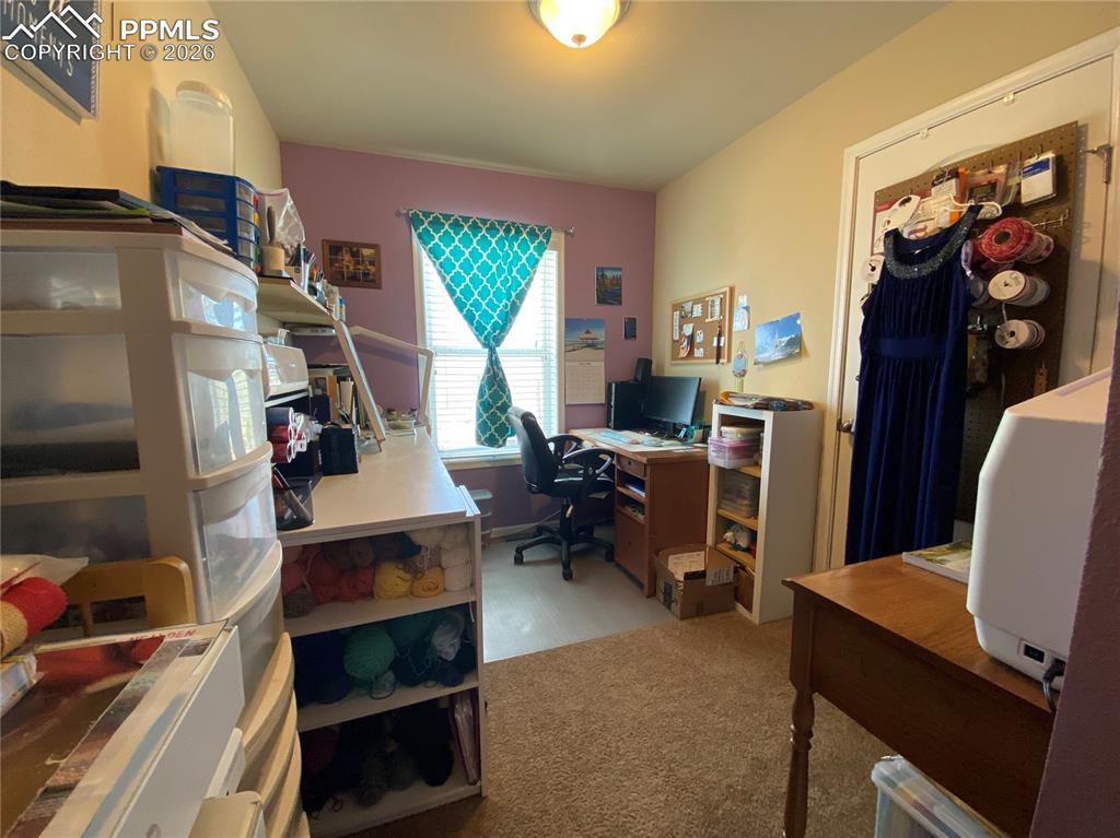 Image 22 of 50: Versatile third bedroom on the main level—perfect for a home office, craft 