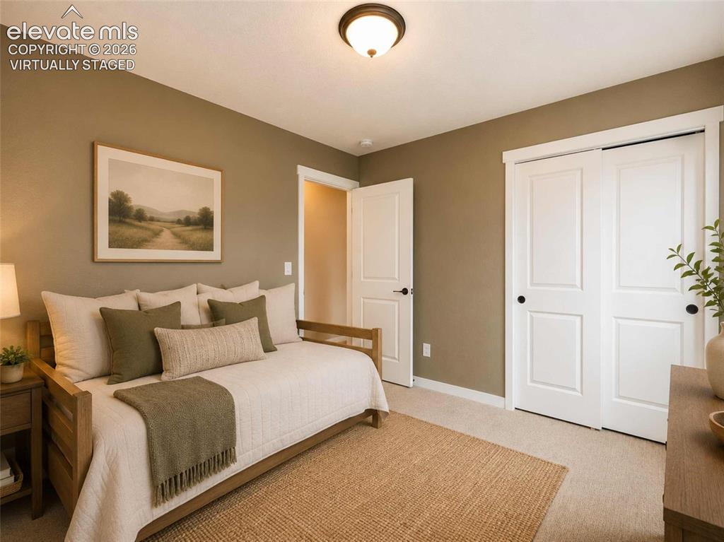 Image 11 of 40: Bedroom with neutral-toned walls complement the light-colored carpet floori