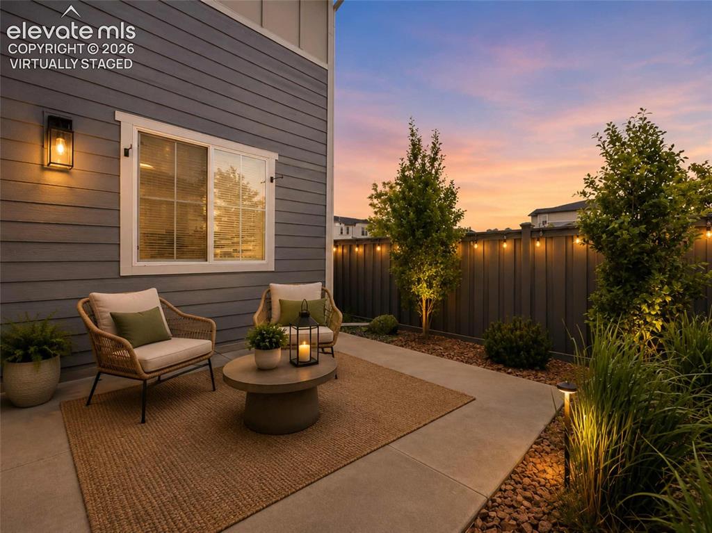 Image 13 of 40: Patio area featuring concrete paving, exterior siding, and a privacy fence