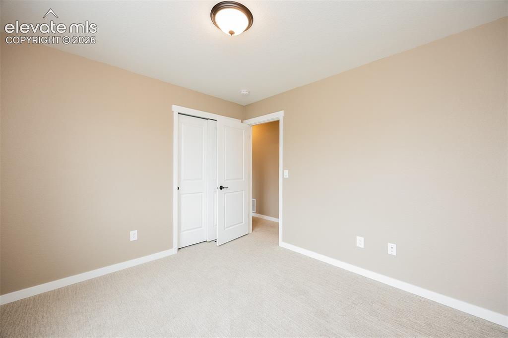 Image 36 of 40: Neutral-toned walls complement light-colored carpeting
