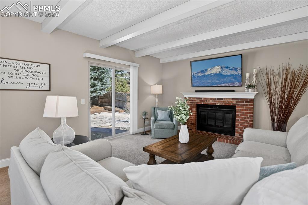 Image 9 of 28: Family room w/ woodburning fireplace