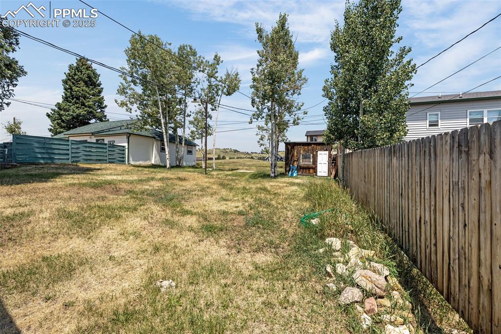 Image 11 of 30: View of yard with a storage unit
