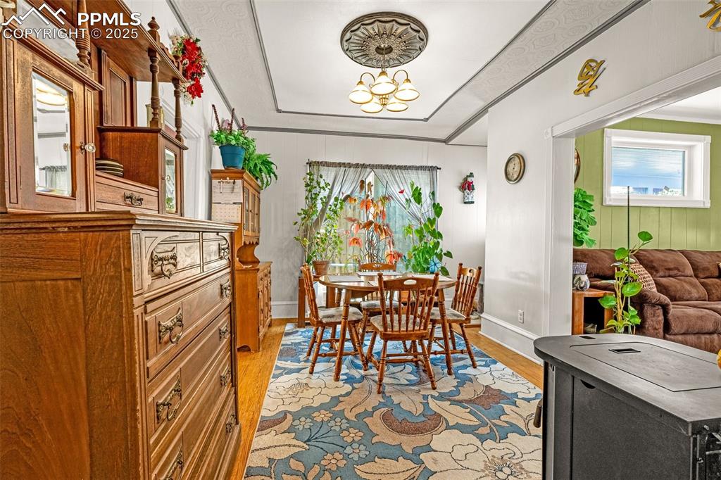 Image 13 of 30: Dining space featuring light wood-style flooring and crown molding