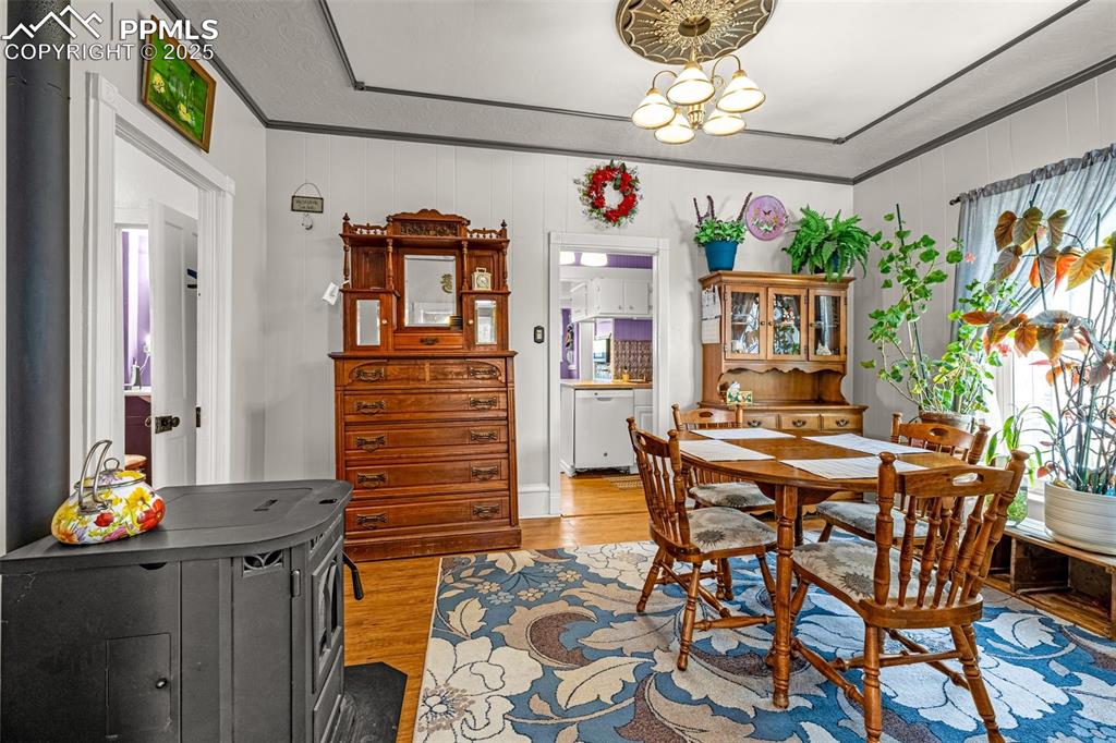 Image 7 of 30: Dining area featuring light wood finished floors, ornamental molding, and a