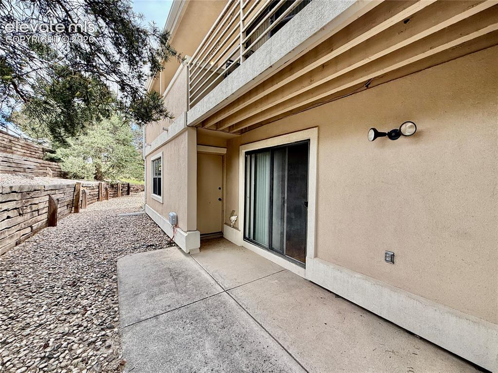 Image 23 of 26: Back of property with stucco siding, a patio area