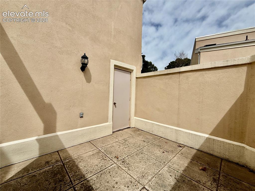 Image 24 of 26: Doorway to additional storage off front private patio