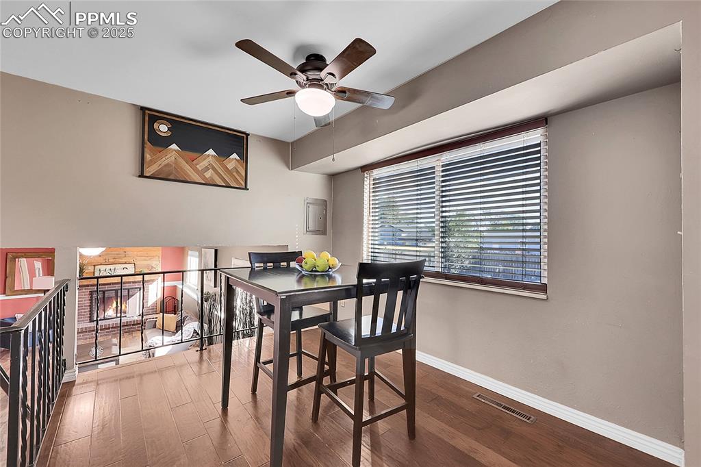 Image 10 of 36: Dining room featuring wood finished floors, a ceiling fan, and electric pan