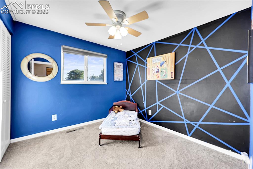 Image 15 of 36: Sitting room featuring an accent wall, carpet flooring, and a ceiling fan