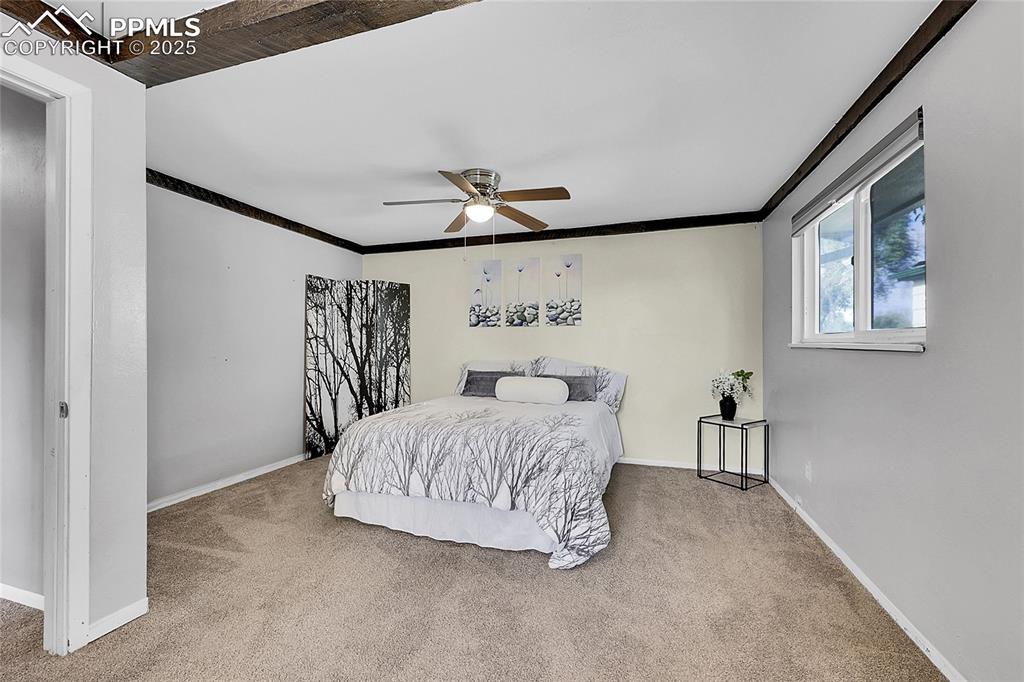 Image 16 of 36: Carpeted bedroom featuring ornamental molding and a ceiling fan