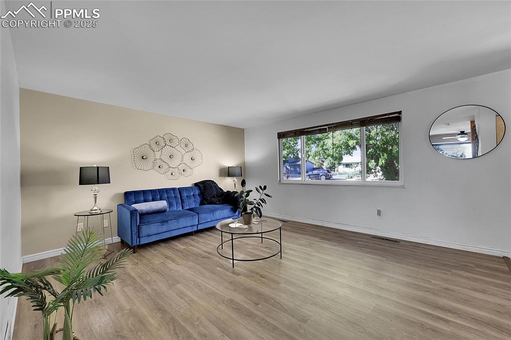 Image 2 of 36: Living area with light wood-type flooring and baseboards