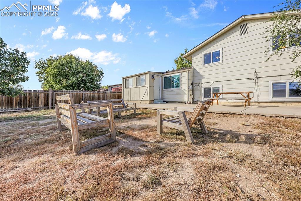 Image 24 of 36: View of fenced backyard
