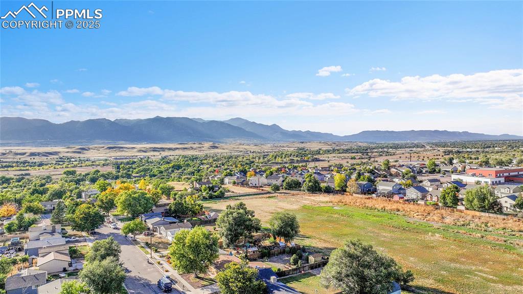 Image 31 of 36: Aerial perspective of suburban area with a mountain backdrop