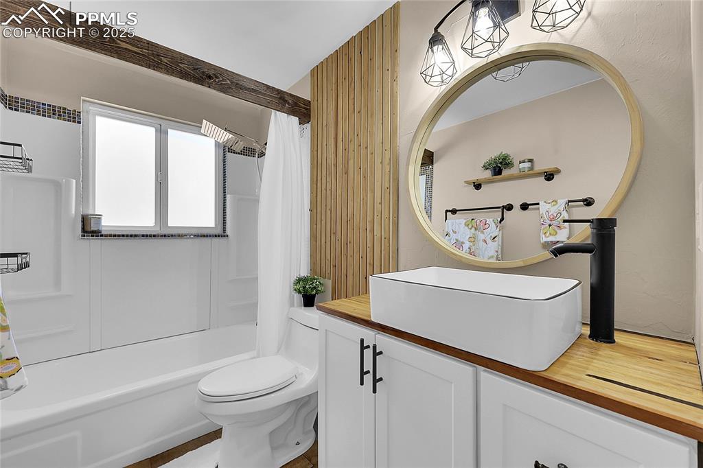 Image 5 of 36: Full bathroom featuring vanity and shower / tub combo