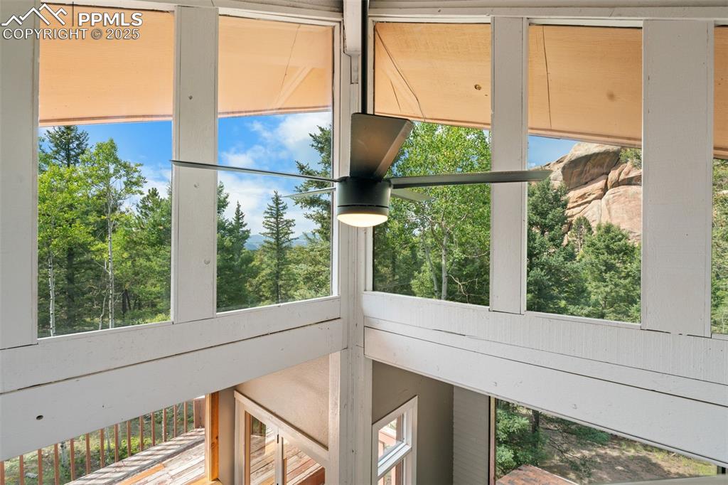 Image 25 of 46: Upper loft windows with views and large fan