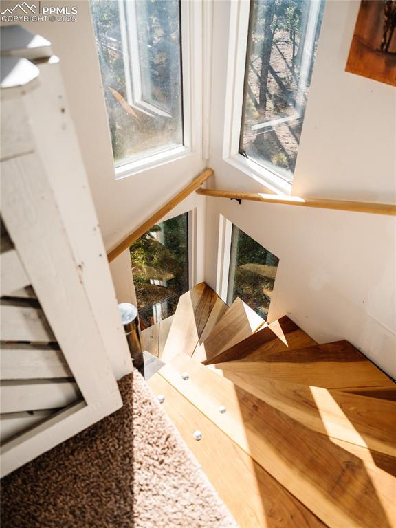 Image 26 of 46: Beautiful natural wood spiral staircases throughout home