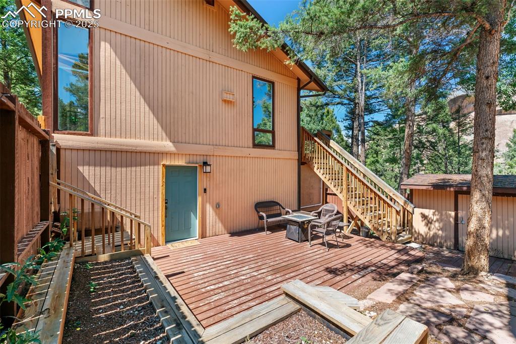Image 37 of 46: Private outdoor patio with raised garden beds and storage shed