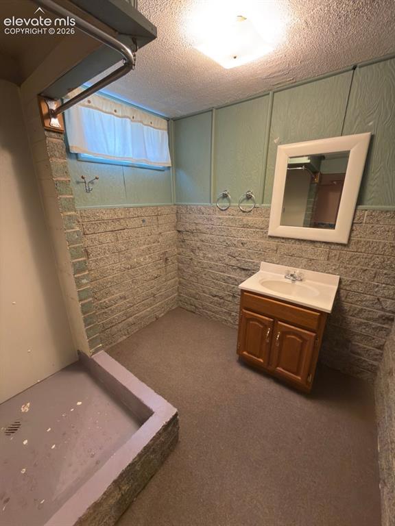 Image 40 of 48: Bathroom featuring a built-in shower area with a shower curtain rod