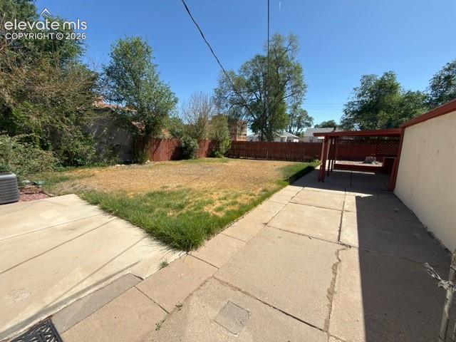 Image 43 of 48: Expansive backyard featuring a concrete patio, a dedicated covered patio ar