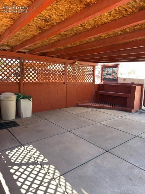 Image 48 of 48: Covered patio featuring a wood beam roof structure with oriented strand boa