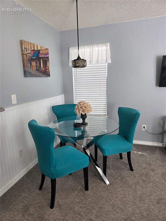 Image 4 of 13: Dining area featuring a contemporary ,pendant lighting, and a window with b
