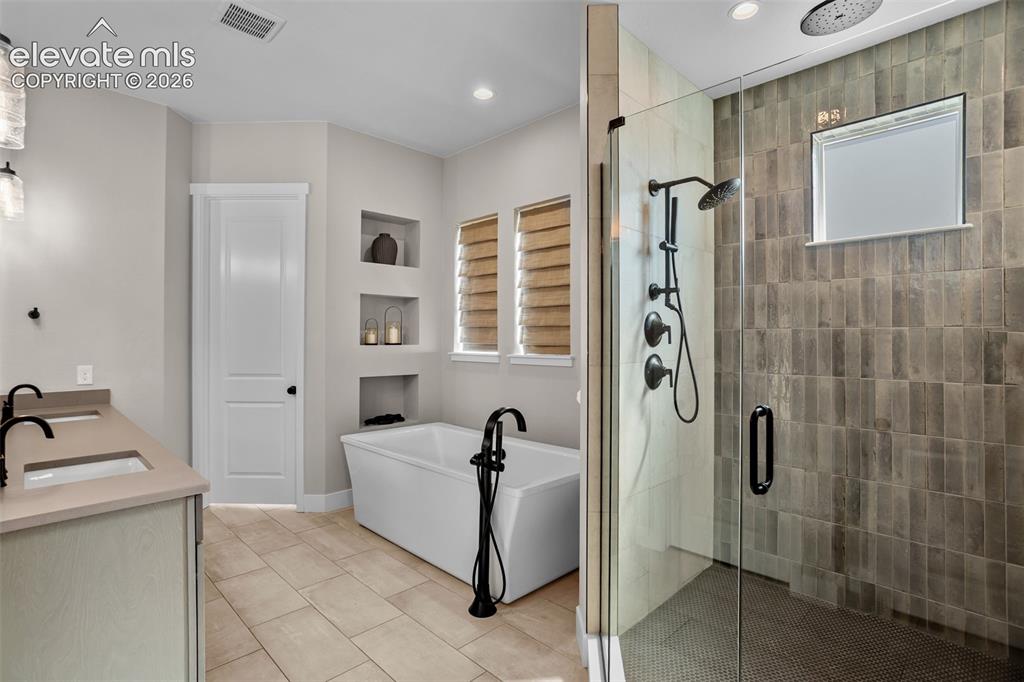 Image 11 of 29: Soaking tub and walk-in shower