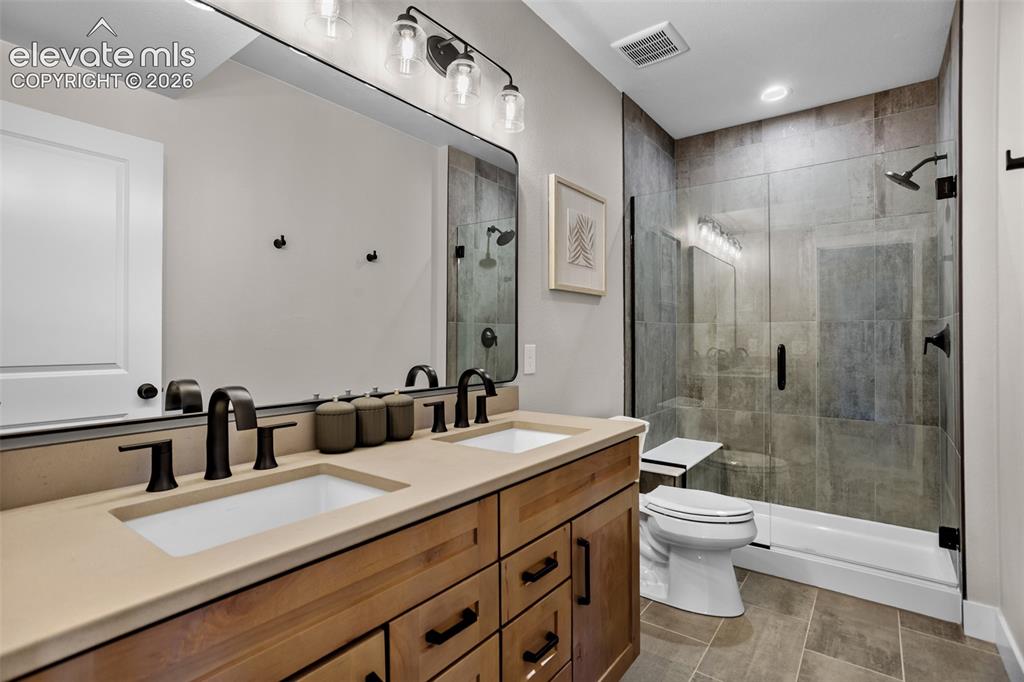 Image 20 of 29: A double sink in the basement bathroom
