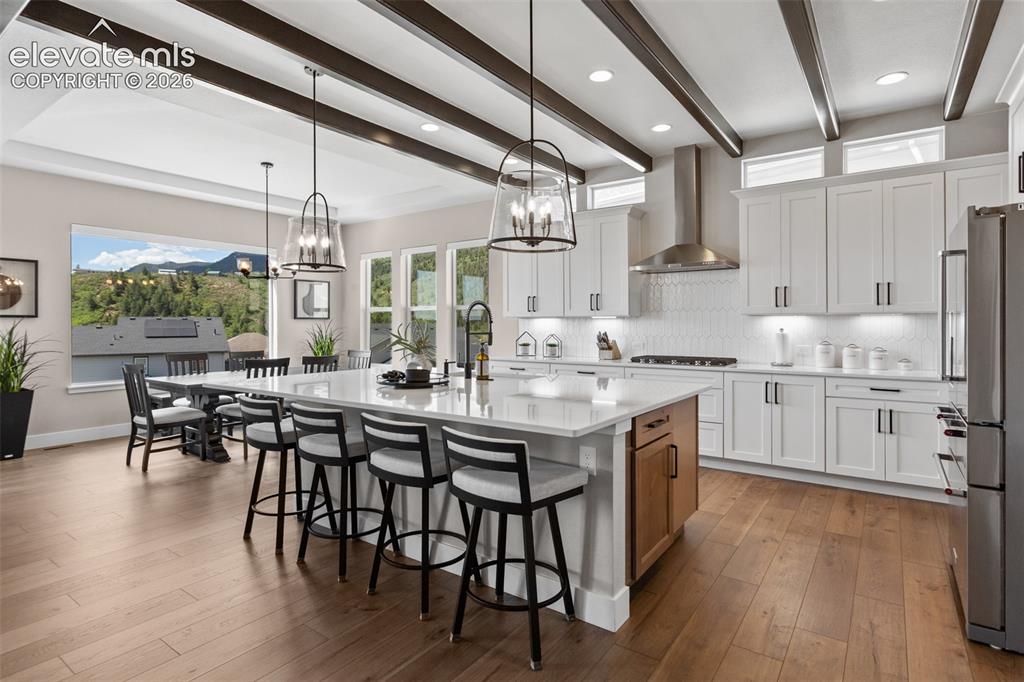Image 5 of 29: A modern kitchen that flows into the living and dining area seamlessly