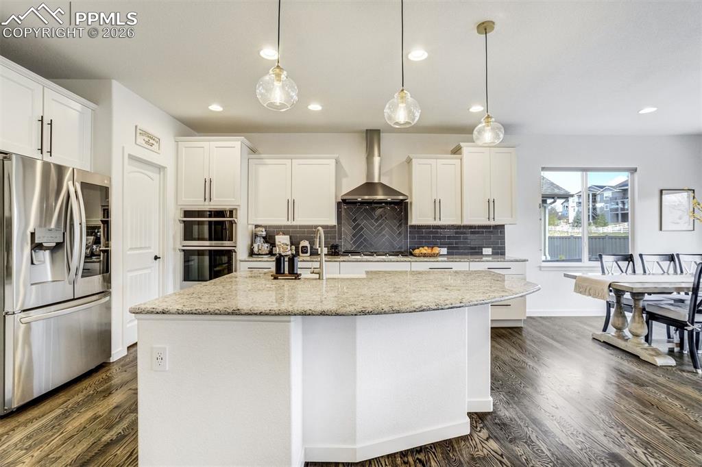 Image 11 of 46: The front planting bed is full of tulips in the spring & a welcoming covere