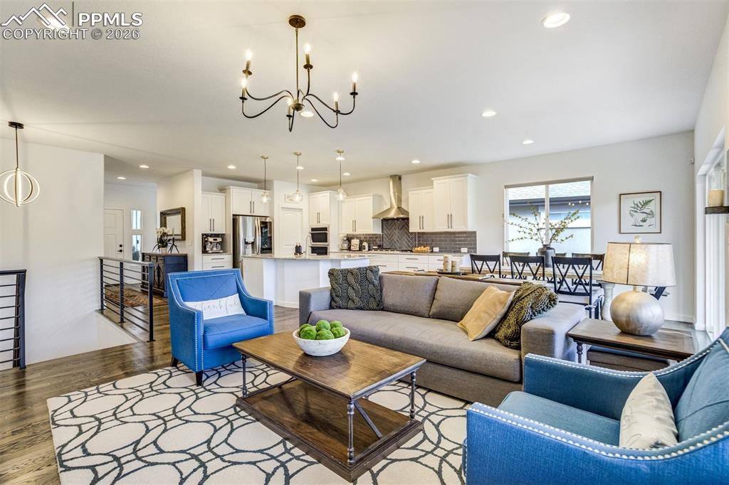 Image 20 of 46: The focal point in the living room is the stacked stone gas fireplace, perf