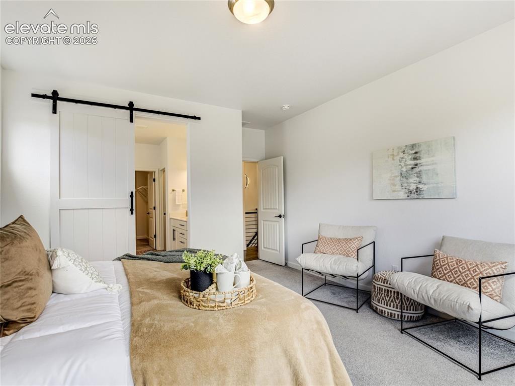 Image 23 of 50: Modern farmhouse details continue throughout the home. The barn style door