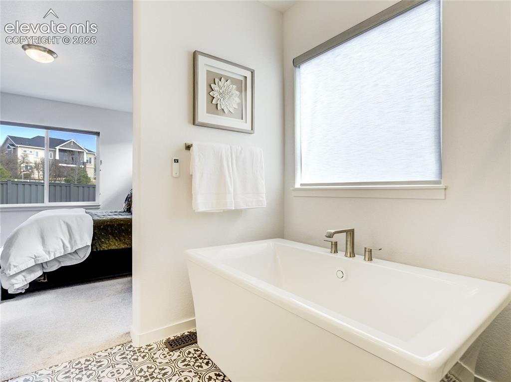 Image 25 of 50: Enjoy a soak in the free-standing tub