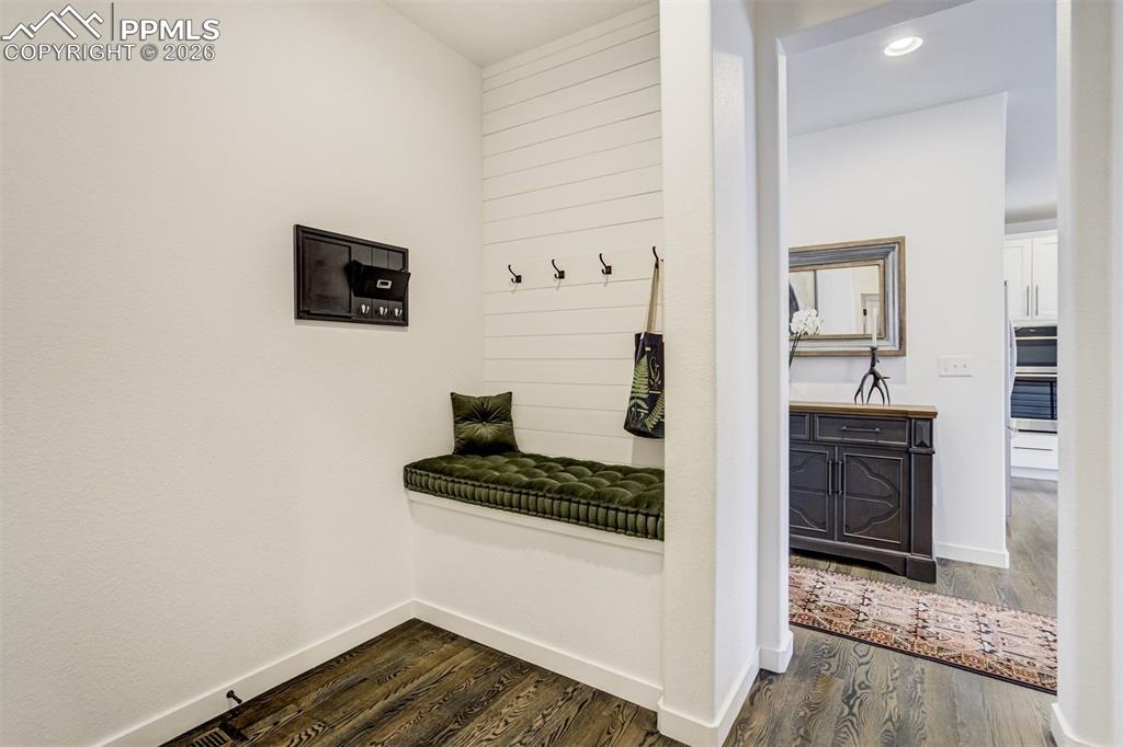 Image 26 of 46: Separated by a rolling barn door, the primary en-suite features a thoughtfu