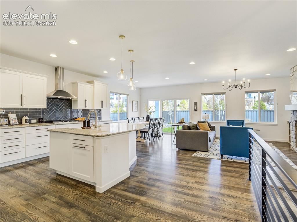 Image 4 of 50: 42-inch cabinetry, a large center island, pantry, decorative tile accents a