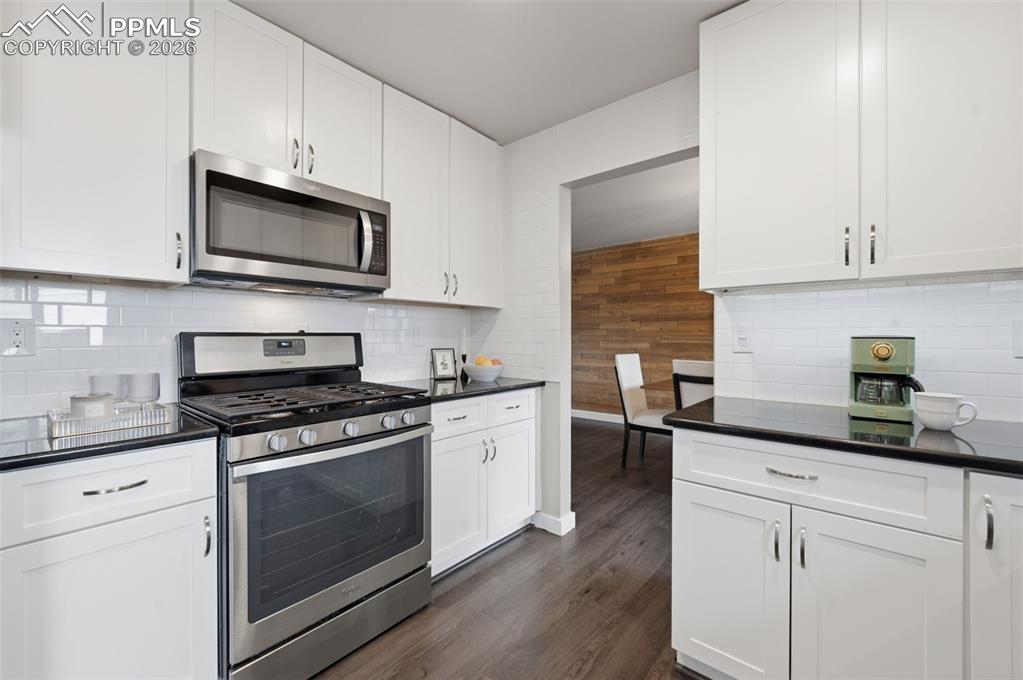 Image 14 of 50: Kitchen wide looking into dining area
