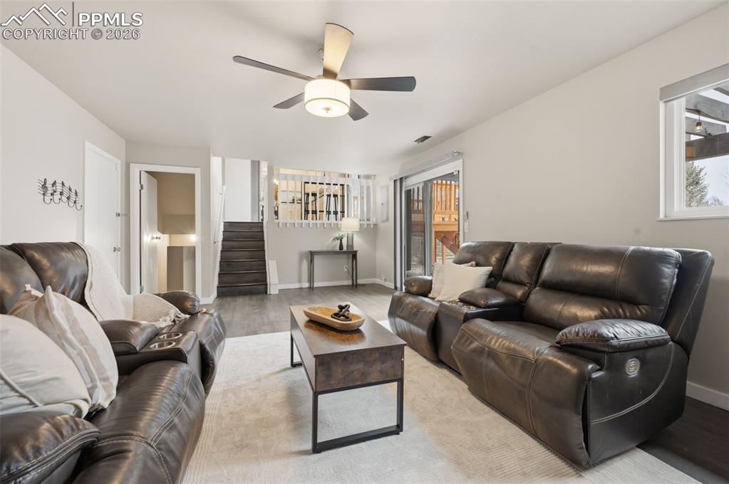 Image 22 of 50: Lower family room facing kitchen and basement entrance