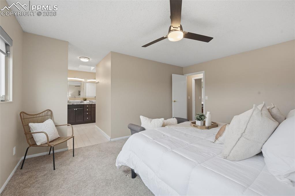 Image 31 of 50: Primary bedroom facing en suite bath 